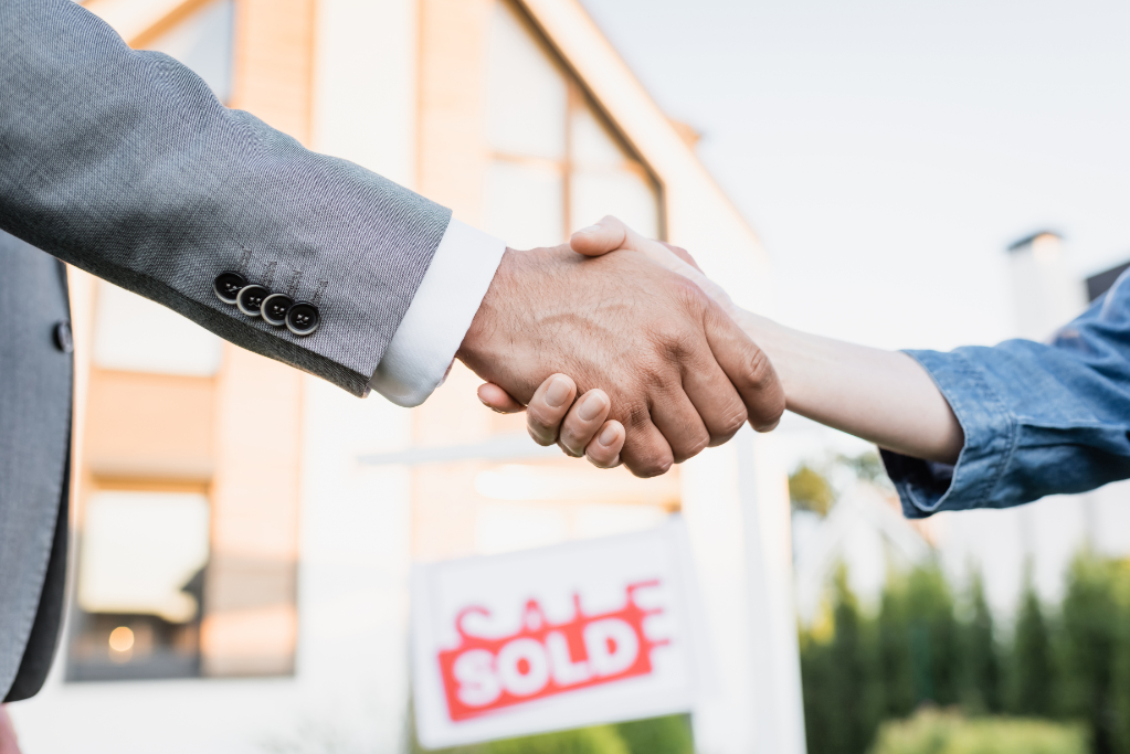 Broker and woman handshaking